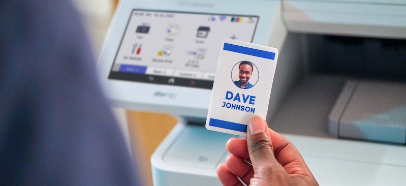 Man holding up his authentication card